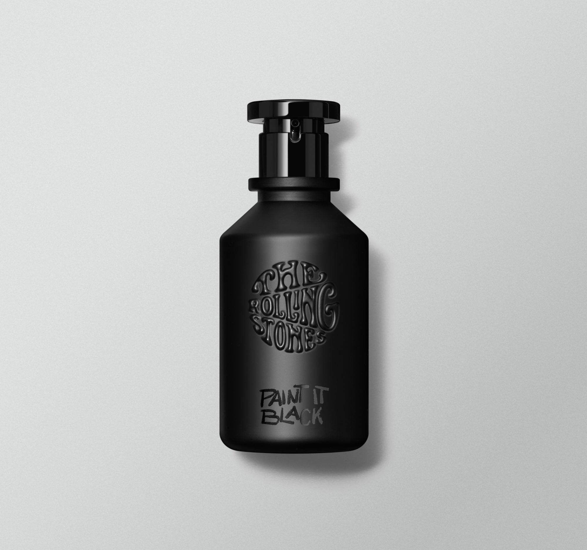 A black perfume bottle with white text 'Paint It Black' on the label, placed against a grey background.