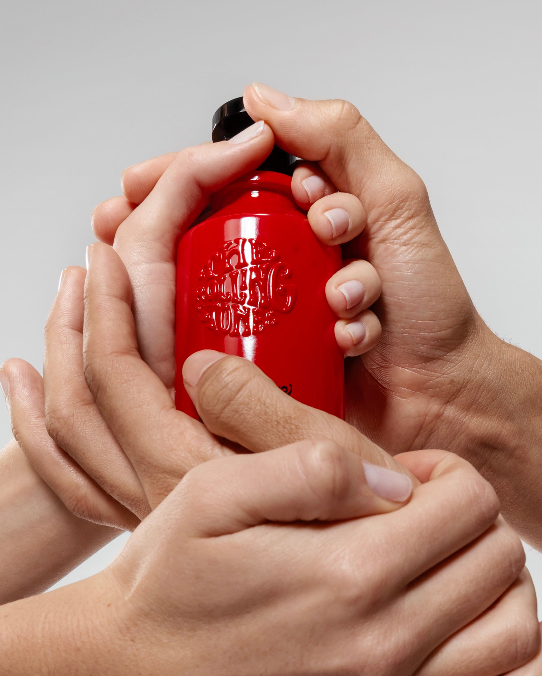 red fragrance bottle of the satisfaction rolling stones collection