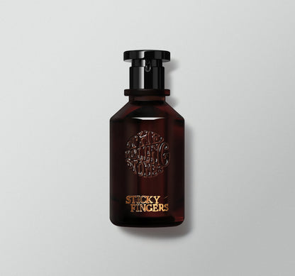 A bottle of perfume labeled 'Sticky Fingers' with a dark liquid visible and a black cap.